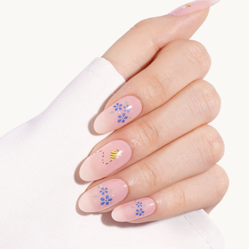ASTRID nude floral UV gel nail strips with blue and yellow flowers
