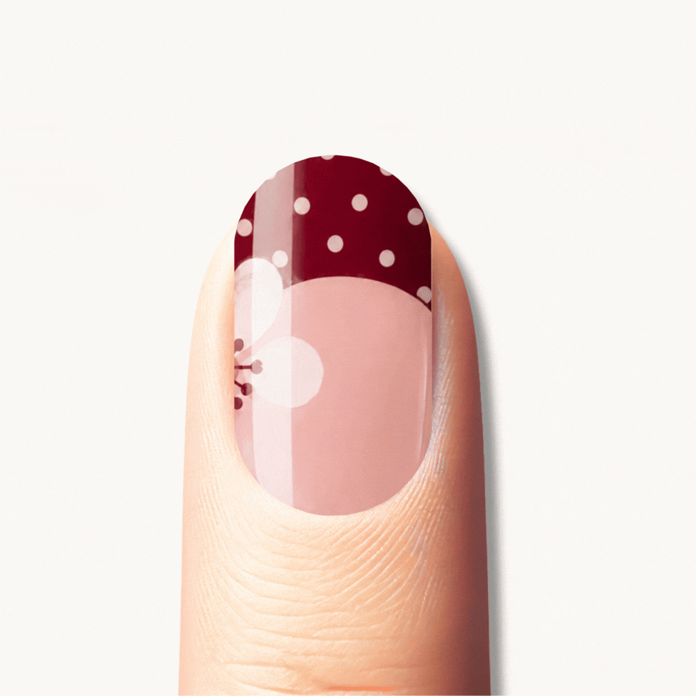 GINNY UV gel nail strips in burgundy and nude with floral and polka dot nail art